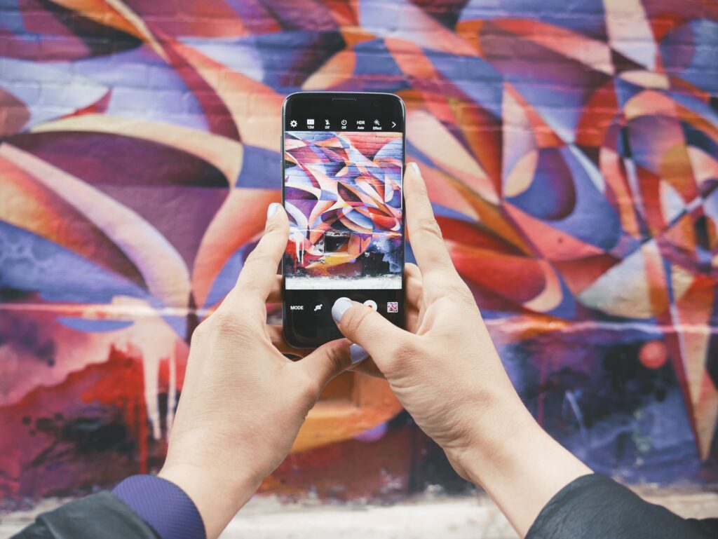 A person taking a photo of a graffiti